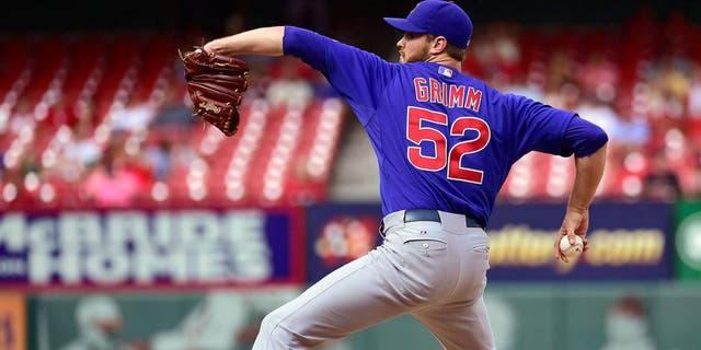 Aug 30, 2014; St. Louis, MO, USA; Chicago Cubs relief pitcher Justin Grimm (52) delivers a pitch against the St. Louis Cardinals during the ninth inning at Busch Stadium. The Cubs defeated the Cardinals 5-1. Mandatory Credit: Scott Rovak-USA TODAY Sports