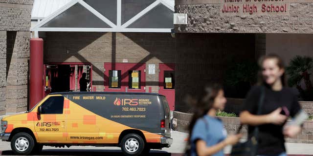 People walk by Walter Johnson Junior High School, Monday, Sept. 12, 2016, in Las Vegas.