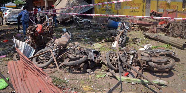 Sept. 12, 2015: A crowd gathers at the site of an explosion near damaged motorbikes in Petlawad district, in the central Indian state of Madhya Pradesh.