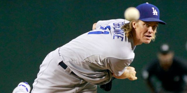 Los Angeles Dodgers starting pitcher Zach Greinke throws against the Arizona Diamondbacks during the first inning of a baseball game, Sunday, Sept. 13, 2015, in Phoenix. (AP Photo/Ralph Freso)