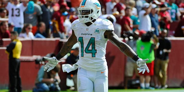 Sep 13, 2015; Landover, MD, USA; Miami Dolphins wide receiver Jarvis Landry (14) celebrates after scoring a touchdown against the Washington Redskins during the second half at FedEx Field. Mandatory Credit: Brad Mills-USA TODAY Sports