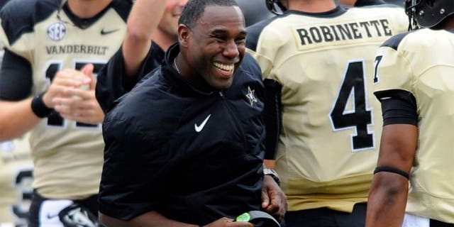 Sep 13, 2014; Nashville, TN, USA; Vanderbilt Commodores head coach Derek Mason celebrates after a touchdown during the first half against the Massachusetts Minutemen at Vanderbilt Stadium. Mandatory Credit: Christopher Hanewinckel-USA TODAY Sports