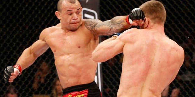 BRASILIA, BRAZIL - SEPTEMBER 13: (L-R) Gleison Tibau of Brazil lands a spinning back fist against Piotr Hallmann of Poland in their lightweight bout during the UFC Fight Night event inside Nilson Nelson Gymnasium on September 13, 2014 in Brasilia, Brazil. (Photo by Josh Hedges/Zuffa LLC/Zuffa LLC via Getty Images)