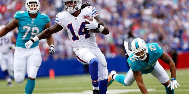 Sep 14, 2014; Orchard Park, NY, USA; Buffalo Bills wide receiver Sammy Watkins (14) runs after a catch as Miami Dolphins strong safety Jimmy Wilson (27) pursues during the first half at Ralph Wilson Stadium. Mandatory Credit: Kevin Hoffman-USA TODAY Sports