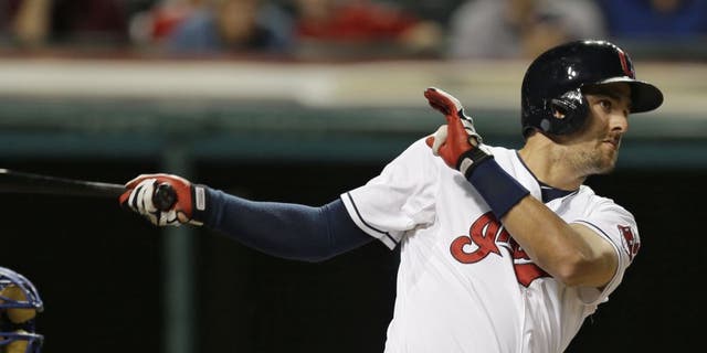 Cleveland Indians' Lonnie Chisenhall hits an RBI-double off Kansas City Royals starting pitcher Edinson Volquez on Monday night
