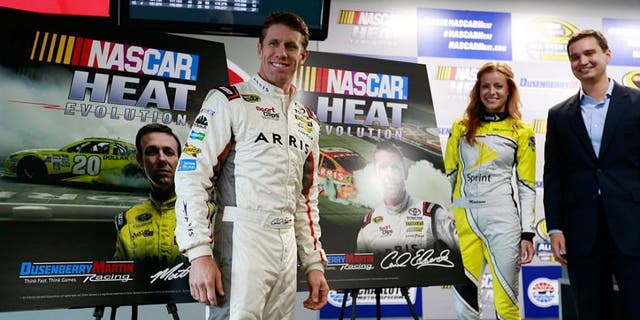 CHARLOTTE, NC - MAY 20: Matt Dusenberry, Director of Partnerships and Revenue at Dusenberry Martin Racing, Carl Edwards, driver of the #19 ARRIS Toyota, and Miss Sprint Cup Madison Martin, speak to the media during a press conference prior to practice for the NASCAR Sprint Cup Series Sprint Showdown at Charlotte Motor Speedway on May 20, 2016 in Charlotte, North Carolina. (Photo by Matt Sullivan/NASCAR via Getty Images)