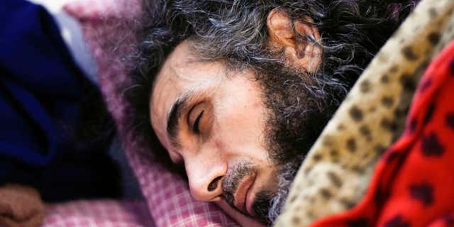FILE - In this Sept. 9, 2016 file photo, Syrian native Abu Wa'el Dhiab rests in bed while conversing with his family via a laptop, in his apartment in Montevideo, Uruguay.