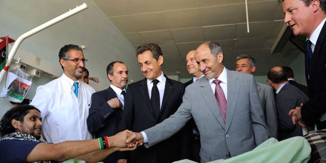 Sept. 15: Leader of Libya's interim government, Mustafa Abdul-Jalil shakes hands with with an unidentified injured man while French President Nicolas Sarkozy, center, and Britain's Prime Minister David Cameron, right, look on in the Tripoli Medical center.