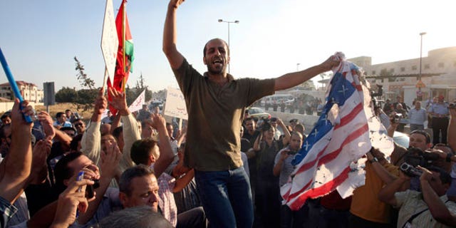 Sept. 14: Jordanian protesters chant anti U.S.A. slogans and burn the American and the Israeli flags in front of the U.S. embassy in Amman, Jordan.