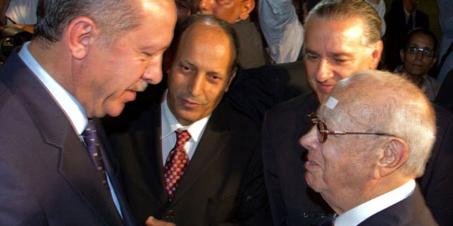 Sept. 14: Tunisian Prime Minister Beji Caid Essebsi, right, greets his Turkish counterpart Recep Tayyip Erdogan , left, at the Tunis-Carthage airport, Tunisia.