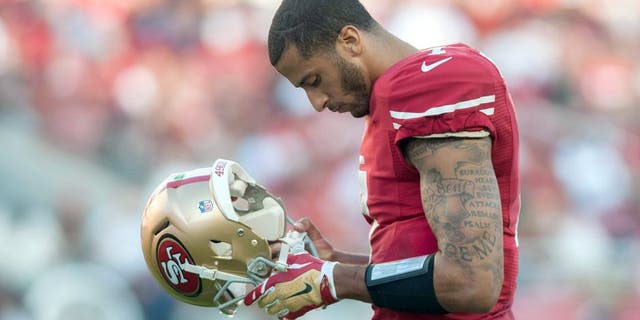Sep 14, 2014; Santa Clara, CA, USA; San Francisco 49ers quarterback Colin Kaepernick (7) looks on during the second quarter of the game against the Chicago Bears at Levi's Stadium. The Chicago Bears defeated the San Francisco 49ers 28-20. Mandatory Credit: Ed Szczepanski-USA TODAY Sports