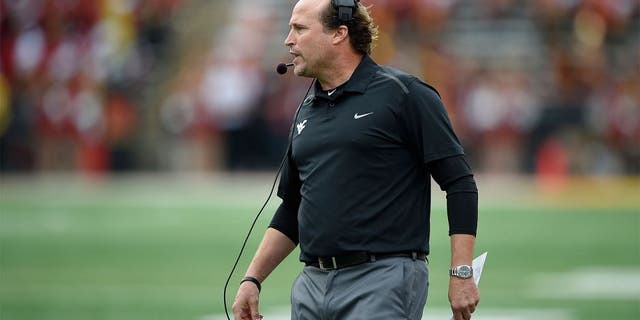 West Virginia head coach Dana Holgorsen looks on during the second half of an NCAA football game against Maryland, Saturday, Sept. 13, 2014, in College Park, Md. West Virginia won 40-37. (AP Photo/Nick Wass)