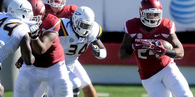 Sep 12, 2015; Little Rock, AR, USA; Arkansas Razorbacks running back Kody Walker (24) runs the ball against the Toledo Rockets during the second quarter at War Memorial Stadium. Mandatory Credit: Mark D. Smith-USA TODAY Sports