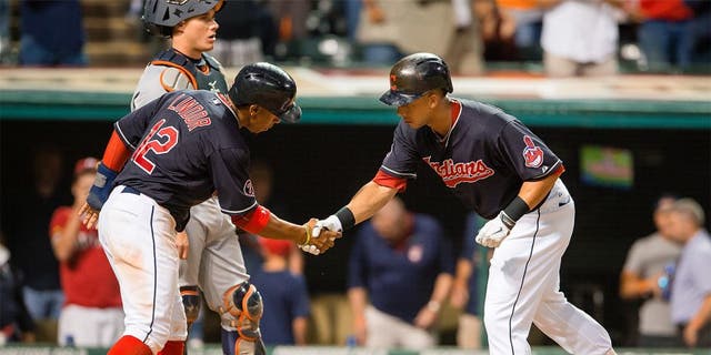 CLEVELAND, OH - SEPTEMBER 10: Francisco Lindor #12 of celebrates with Michael Brantley #23 of the Cleveland Indians after Brantley hit a two run home run during the eighth inning against the Detroit Tigers at Progressive Field on September 10, 2015 in Cleveland, Ohio. (Photo by Jason Miller/Getty Images)