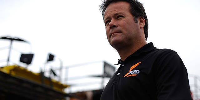 LOUDON, NH - SEPTEMBER 23: Robby Gordon, driver of the #7 Speed Energy Dodge, walks through the garage area during practice for the NASCAR Sprint Cup Series Sylvania 300 at New Hampshire Motor Speedway on September 23, 2011 in Loudon, New Hampshire. (Photo by Jason Smith/Getty Images for NASCAR)