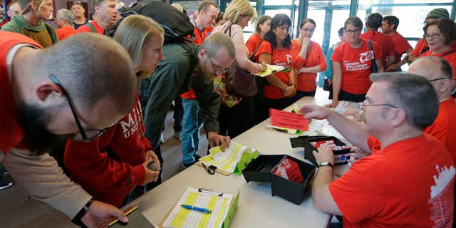 Sept. 15, 2015: Members of the Seattle Education Association, the union that represents striking teachers from the Seattle School District, sign in to receive voting cards as they arrive at a meeting hall in Seattle to discuss a tentative contract agreement that was reached with the district Tuesday morning, the fifth day of the strike.