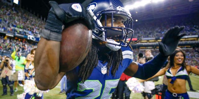 SEATTLE, WA - SEPTEMBER 15: Cornerback Richard Sherman #25 of the Seattle Seahawks celebrates after making an interception in the second half against the San Francisco 49ers at CenturyLink Field on September 15, 2013 in Seattle, Washington. (Photo by Otto Greule Jr/Getty Images)