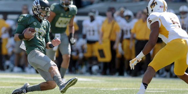Sep 13, 2014; Eugene, OR, USA; Oregon Ducks quarterback Jeff Lockie (17) slides to avoid a hit form Wyoming Cowboys safety Jesse Sampson (5) at Autzen Stadium. Mandatory Credit: Scott Olmos-USA TODAY Sports