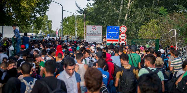 Sept. 16, 2015: Migrants demonstrate at the border crossing into Hungary, near Horgos, Serbia