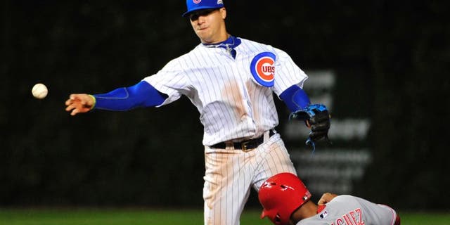 Chicago Cubs shortstop Javier Baez, left, forces out Cincinnati Reds' Yorman Rodriguez (33) at second base during the fourth inning of a baseball game, Wednesday, Sept. 17, 2014 in Chicago. (AP Photo/David Banks)