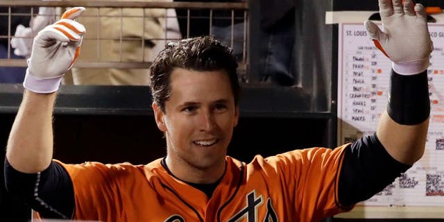San Francisco Giants' Buster Posey jokes with teammates in the dugout after his two-run home run against the St. Louis Cardinals during the fourth inning of a baseball game Friday, Sept. 16, 2016, in San Francisco.
