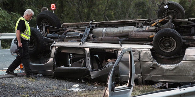 Sept. 18: State police investigate the scene of a fatal accident in Woodbury, N.Y. A passenger van carrying members of a church flipped over killing at least six people and injuring eight others, authorities said.