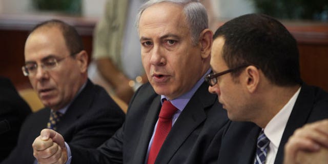 Sept. 18: Israeli Prime Minister Benjamin Netanyahu, center, talks during a weekly cabinet meeting in Jerusalem.