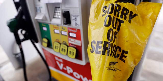 A bag covers a pump handle at a gas station that has no fuel to sell Saturday, Sept. 17, 2016, in Nashville, Tenn.