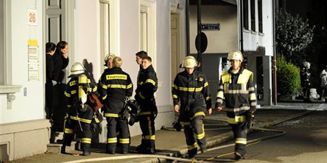 Sept. 19: Firefighters stand in front of a house where an explosion occured in Loerrach, southern Germany.