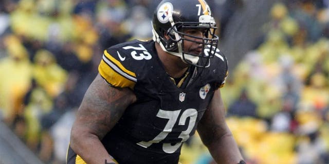Dec 29, 2013; Pittsburgh, PA, USA; Pittsburgh Steelers guard Ramon Foster (73) blocks at the line of scrimmage against the Cleveland Browns during the fourth quarter at Heinz Field. The Steelers won 20-7. Mandatory Credit: Charles LeClaire-USA TODAY Sports