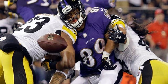 Baltimore Ravens wide receiver Steve Smith (89) can't hang on to a pass as he is hit by Pittsburgh Steelers free safety Mike Mitchell (23) and strong safety Troy Polamalu (43) during the second half of an NFL football game Thursday, Sept. 11, 2014, in Baltimore. (AP Photo/Patrick Semansky)