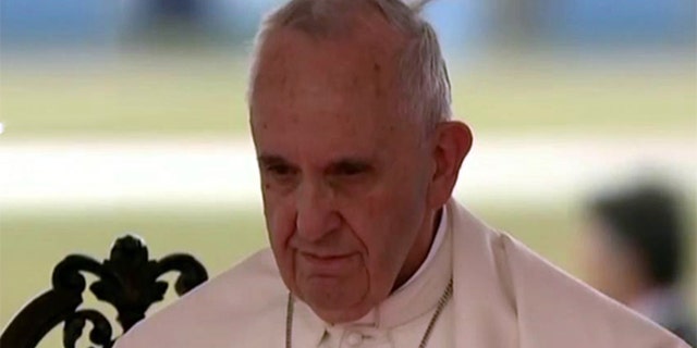 Pope Francis stands beside Cuban leader Raul Castro (not pictured) after arriving in Havana on Saturday September 19, 2015.