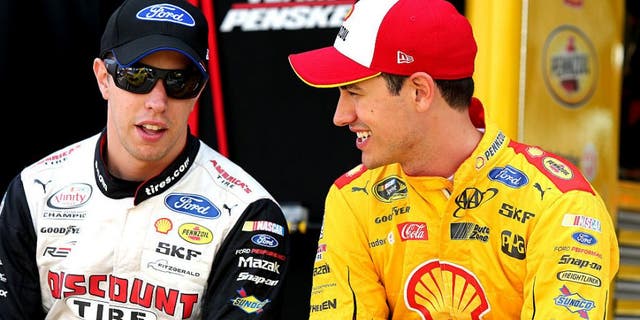 BRISTOL, TN - AUGUST 19: Brad Keselowski, driver of the #2 Autotrader Ford, talks to Joey Logano, driver of the #22 Shell Pennzoil Ford, on the grid during qualifying for the NASCAR Sprint Cup Series Bass Pro Shops NRA Night Race at Bristol Motor Speedway on August 19, 2016 in Bristol, Tennessee. (Photo by Jerry Markland/Getty Images)