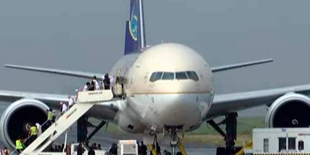 Sept. 20, 2016: In this image made from video, people disembark a Saudi Arabian Airlines plane from Jeddah as it is parked at the airport in Manila, the Philippines.