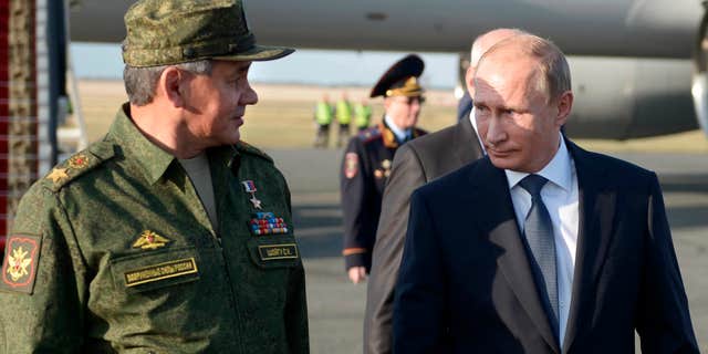 Sept. 19, 2015: Russian President Vladimir Putin speaks with Defense Minister Sergei Shoigu on his arrival in Orenburg region, about 800 miles southeast of Moscow, Russia.