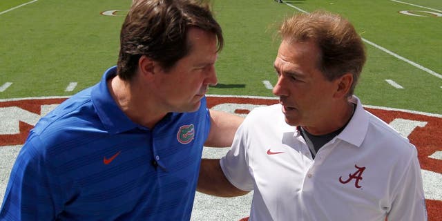 Florida head coach Will Muschamp, left, talks with Alabama coach Nick Saban before an NCAA college football game against on Saturday, Sept. 20, 2014, in Tuscaloosa, Ala. (AP Photo/Butch Dill)