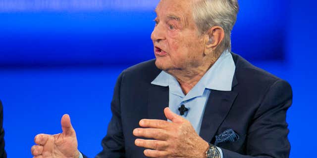 FILE - In this Sept. 27, 2015, file photo, George Soros, chairman of Soros Fund Management, talks during a television interview for CNN at the Clinton Global Initiative in New York.