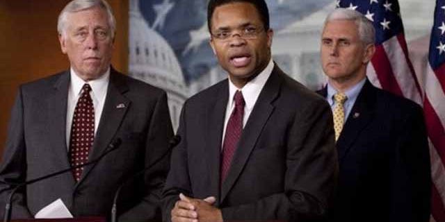 April 14: Rep. Jesse Jackson Jr., D-Ill., flanked by House Majority Leader Steny Hoyer of Md., left, and Rep. Mike Pence, R-Ind., addresses a news conference on Capitol Hill in Washington.