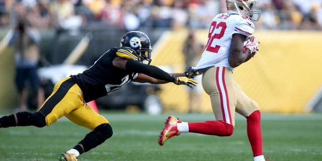 Sep 20, 2015; Pittsburgh, PA, USA; San Francisco 49ers wide receiver Torrey Smith (82) carries the ball away from Pittsburgh Steelers strong safety Will Allen (20) on a seventy-five yard touchdown catch during the fourth quarter at Heinz Field. The Steelers won 43-18. Mandatory Credit: Charles LeClaire-USA TODAY Sports