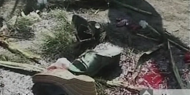 Sept. 22: Bloodstained debris litter the street after a bomb blast in Mahabad Iran.