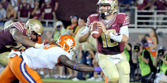 Sep 20, 2014; Tallahassee, FL, USA; Florida State Seminoles quarterback Sean Maguire (10) is pressured during the first half against the Clemson Tigers at Doak Campbell Stadium. Mandatory Credit: Melina Vastola-USA TODAY Sports