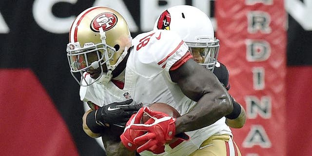 GLENDALE, AZ - SEPTEMBER 21: Wide receiver Anquan Boldin #81 of the San Francisco 49ers is hit by safety Tyrann Mathieu #32 of the Arizona Cardinals during the second quarter of the NFL game at University of Phoenix Stadium on September 21, 2014 in Glendale, Arizona. (Photo by Norm Hall/Getty Images)