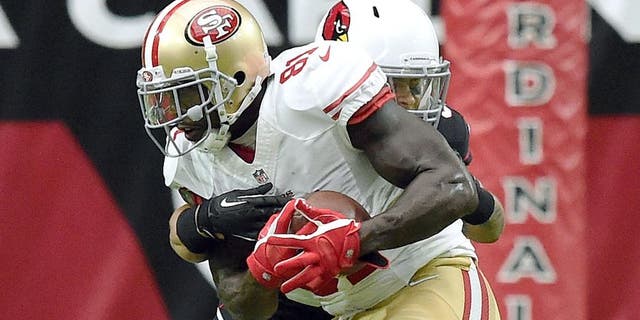 GLENDALE, AZ - SEPTEMBER 21: Wide receiver Anquan Boldin #81 of the San Francisco 49ers is hit by safety Tyrann Mathieu #32 of the Arizona Cardinals during the second quarter of the NFL game at University of Phoenix Stadium on September 21, 2014 in Glendale, Arizona. (Photo by Norm Hall/Getty Images)