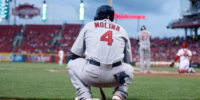 CINCINNATI, OH - SEPTEMBER 11: Yadier Molina #4 of the St. Louis Cardinals waits for his chance to bat during the game against the Cincinnati Reds at Great American Ball Park on September 11, 2015 in Cincinnati, Ohio. (Photo by Kirk Irwin/Getty Images)