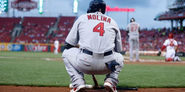 CINCINNATI, OH - SEPTEMBER 11: Yadier Molina #4 of the St. Louis Cardinals waits for his chance to bat during the game against the Cincinnati Reds at Great American Ball Park on September 11, 2015 in Cincinnati, Ohio. (Photo by Kirk Irwin/Getty Images)