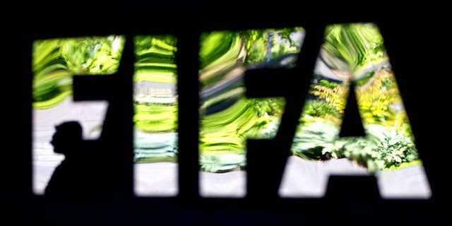 ZURICH, SWITZERLAND - JUNE 03: A FIFA logo sits next to the entrance at the FIFA headquarters on June 3, 2015 in Zurich, Switzerland. Joseph S. Blatter resigned as president of FIFA. The 79-year-old Swiss official, FIFA president for 17 years said a special congress would be called to elect a successor. (Photo by Philipp Schmidli/Getty Images)