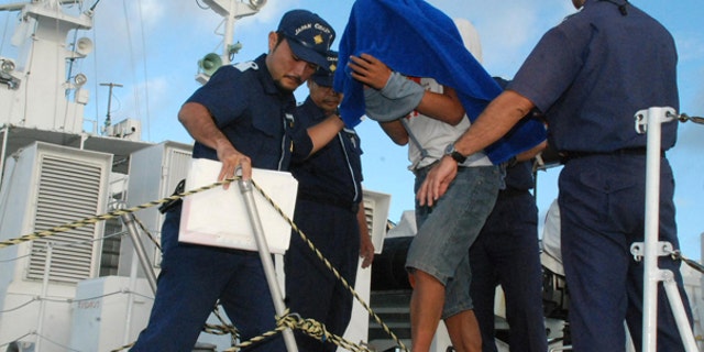 Sept. 8: Japan Coast Guard personnel disembark Zhan Qixiong, the 41-year-old Chinese captain of a Chinese fishing boat, center, at a port on Ishigaki island. The boat collided with two Japanese patrol vessels near disputed islands causing more than 2 weeks of strained relations between the two countries, before Japan announced the captain's release.