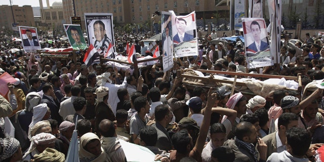 Sept. 21: Anti-government protestors carry the bodies of Yemeni men who were killed in the recent clashes with security forces, during their funeral procession in Sanaa, Yemen.