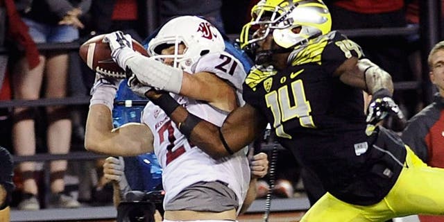 Sep 20, 2014; Pullman, WA, USA; Washington State Cougars wide receiver River Cracraft (21) makes a catch against Oregon Ducks defensive back Ifo Ekpre-Olomu (14) during the second half at Martin Stadium. The Ducks beat Cougars 38-31. Mandatory Credit: James Snook-USA TODAY Sports