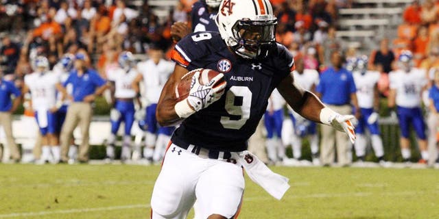 Sep 6, 2014; Auburn, AL, USA; Auburn Tigers running back Roc Thomas (9) carries against the San Jose State Spartans during the second half at Jordan Hare Stadium. The Tigers beat the Spartans 59-13. Mandatory Credit: John Reed-USA TODAY Sports